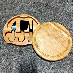 Cheese or charcuterie board with serving utensils inside